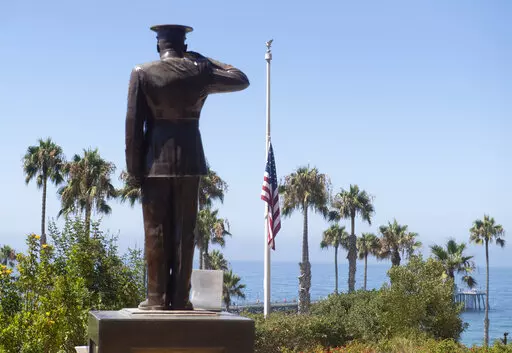 In this July 31, 2020, file photo, the U.S. flag is seen lowered to half-staff at Park Semper Fi in San Clemente, Calif., after a seafaring assault vehicle sank off the coast of Southern California. A Marine Corps panel convenes Tuesday, Jan. 4, 2022, to decide if an officer should be discharged over the sinking of the amphibious assault vehicle that killed nine service members. (Paul Bersebach/The Orange County Register via AP, File)