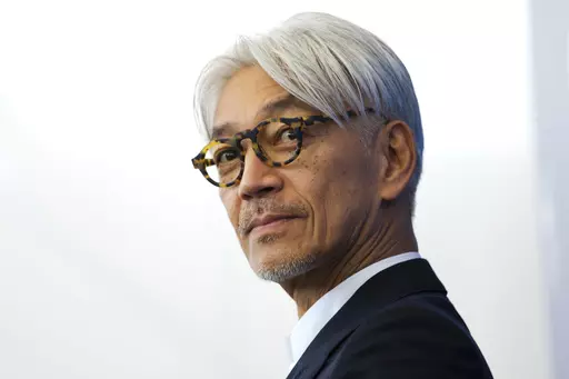 Maestro Ryuichi Sakamoto poses during a photo call for the film "Coda" at the 74th Venice Film Festival in Venice, Italy, Sept. 3, 2017. Japan's recording company Avex says Sakamoto, a musician who scored for Hollywood movies such as “The Last Emperor” and “The Revenant,” has died. He was 71. He died March 28, according to the statement released Sunday, April 2, 2023. (AP Photo/Domenico Stinellis, File)