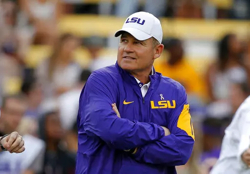 In this Oct. 17, 2015, file photo, LSU coach Les Miles watches his team warm up before an NCAA college football game against Florida in Baton Rouge, La. A former student who accused ex-LSU football coach Les Miles of sexual harassment in 2013 sought a $2.15 million settlement with LSU and Miles, according to documents filed in a former athletic department official's lawsuit. (AP Photo/Gerald Herbert, File)