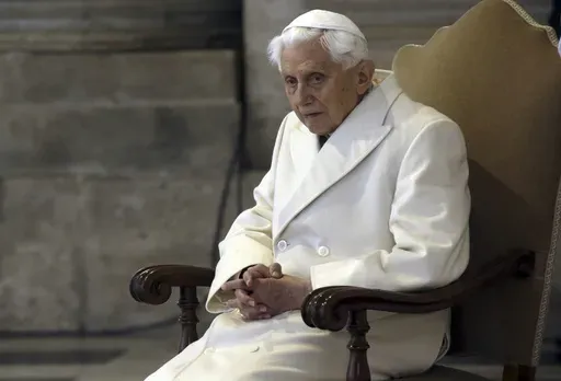 Pope Emeritus Benedict XVI sits in St. Peter's Basilica as he attends the ceremony marking the start of the Holy Year, at the Vatican, Dec. 8, 2015. The Vatican next year will publish a collection of private homilies delivered by the late Pope Benedict XVI for his Sunday Masses, most of them penned during his 10-year retirement, officials said Saturday, Dec. 23, 2023. (AP Photo/Gregorio Borgia, File)