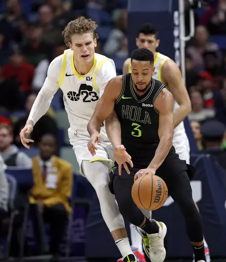 New Orleans Pelicans guard CJ McCollum (3) steals the ball from Utah Jazz forward Lauri Markkanen (23) in the first half of an NBA basketball game in New Orleans, Tuesday, Jan. 23, 2024. (AP Photo/Tyler Kaufman)