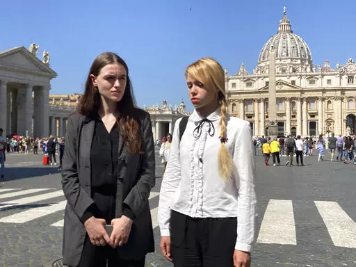 Kateryna Prokopenko, right, wife of Azov Regiment Commander Denys Prokopenko, and Yuliia Fedosiuk, both from Ukraine, talk with The Associated Press at the end of the weekly general audience where they met with Pope Francis in St. Peter's Square at The Vatican, Wednesday, May 11, 2022. (AP Photo/Nicole Winfield)