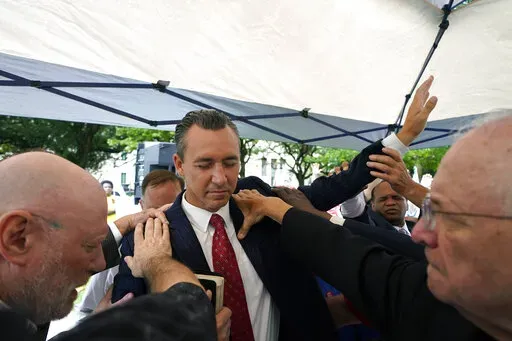 Tony Spell, pastor of the Life Tabernacle Church of Central City, La., prays with supporters outside the Fifth Circuit Court of Appeals in New Orleans on June 7, 2021. Spell's lawsuit over Gov. John Bel Edwards’ past COVID-19 restrictions on public gatherings was rejected for a second time Wednesday, Jan. 12, 2022, by a federal judge. Spell garnered national attention in March 2020 when he began to flout the state’s public health order at a time when much of the country was in lockdown over 
