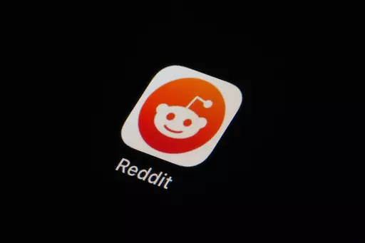 The Reddit app icon is seen on a smartphone on Feb. 28, 2023, in Marple Township, Pa. More than 8,000 subreddits, or Reddit communities, have gone dark as of Tuesday, June 13, in protest of upcoming API changes, which include a controversial policy that will charge some third-party apps for continued use. (AP Photo/Matt Slocum, File)
