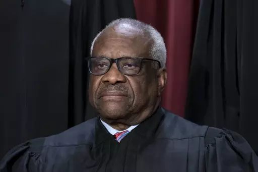 Associate Justice Clarence Thomas joins other members of the Supreme Court as they pose for a new group portrait, at the Supreme Court building in Washington, Oct. 7, 2022. Thomas has for more than two decades accepted luxury trips nearly every year from Republican megadonor Harlan Crow without reporting them on financial disclosure forms, ProPublica reports. (AP Photo/J. Scott Applewhite, File)