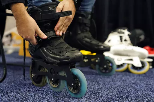 Mohamed Soliman of Atmos Gear dons Atmos Gear inline electric skates during CES Unveiled before the start of the CES tech show, Tuesday, Jan. 3, 2023, in Las Vegas. More than a thousand startups are showcasing their products at the annual CES tech show in Las Vegas, hoping to create some buzz around their gadgets and capture the eyes of investors who can help their businesses grow.(AP Photo/John Locher, File)