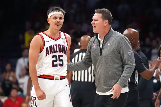 Arizona head coach Tommy Lloyd, right, talks to guard Kerr Kriisa (25) during the first half of an NCAA college basketball game against Southern University, Friday, Nov. 11, 2022, in Tucson, Ariz. (AP Photo/Rick Scuteri)