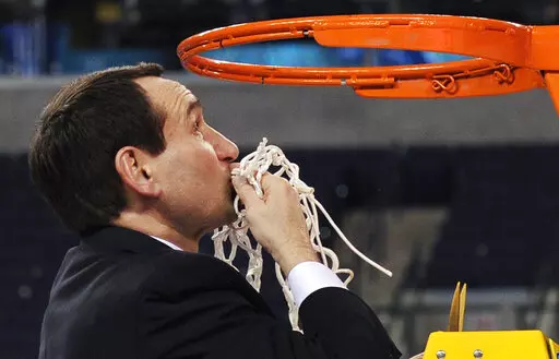 Duke head coach Mike Krzyzewski kisses the net after cutting it down following Duke's 61-59 win over Butler in the men's NCAA Final Four college basketball championship game Monday, April 5, 2010, in Indianapolis. Krzyzewski's unparalleled coaching career is down to a few basketball games, with no more than a month left before the retiring Duke Hall of Famer walks off the sideline for the last time. (AP Photo/Mark J. Terrill, File)