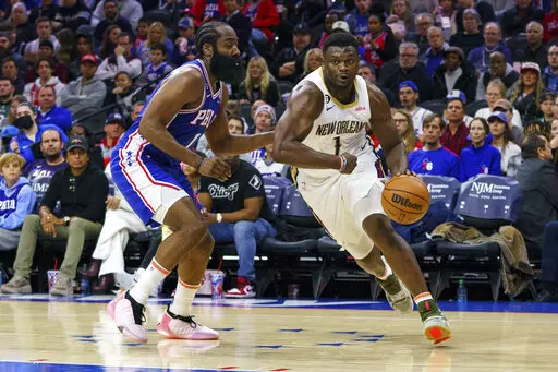 New Orleans Pelicans' Zion Williamson, right, drives to the basket against Philadelphia 76ers' James Harden, left, during the second half of an NBA basketball game, Monday, Jan. 2, 2023, in Philadelphia. (AP Photo/Chris Szagola)