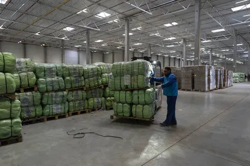UNHCR staff load a truck with supplies for Ukraine in an aid warehouse at Rzeszow airport, in Rzeszow, southeastern Poland, Wednesday, March 16, 2022. (AP Photo/Petros Giannakouris)