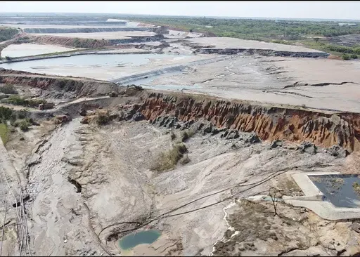 This image taken from video Wednesday, Feb. 19, 2025, shows a breach at a tailing dam at a Sino-Metals Leach Zambia mine near Kitwe. (AP Photo/Richard Kille )