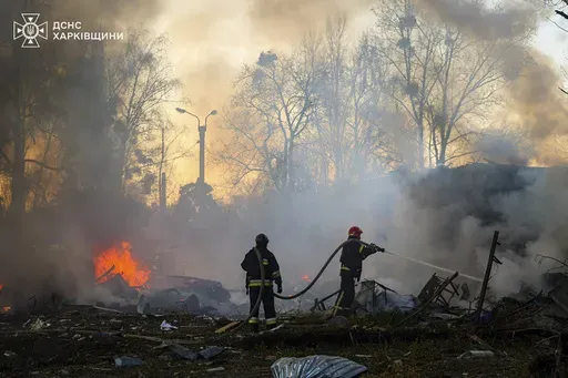 In this photo provided by the Ukrainian Emergency Service, firefighters put out the fire following a Russian rocket attack in Kharkiv, Ukraine, Friday, March 7, 2025. (Ukrainian Emergency Service via AP)