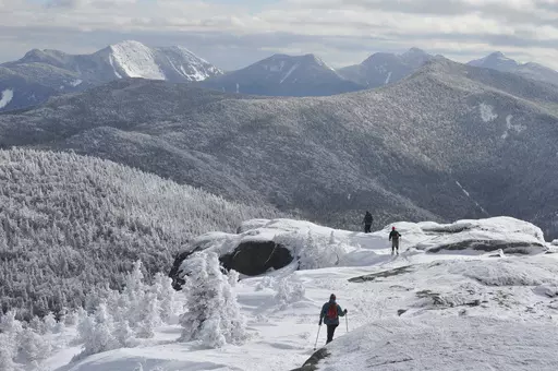 Three snowshoers descend from the summit of Cascade Mountain in the Adirondacks, March 14, 2011. Forest rangers successfully rescued an upstate New York hiker who survived a frigid night trapped precariously above a cliff on a rugged Adirondack mountain peak after slipping hundreds of feet down from the summit. (Mike Lynch/Adirondack Daily Enterprise via AP)
