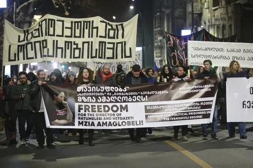 Protesters hold banners calling for the release of jailed journalist Mzia Amaghlobeli as they march through the streets in Tbilisi, Georgia, on Wednesday, Jan. 29, 2025. (AP Photo/Zurab Tsertsvadze)