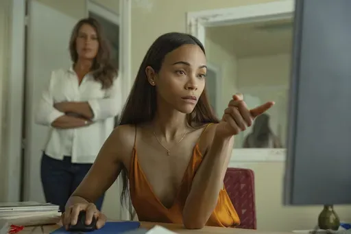 This image released by Netflix shows Karla Sofía Gascón, left, and Zoe Saldaña in a scene from "Emilia Pérez." (Netflix via AP)