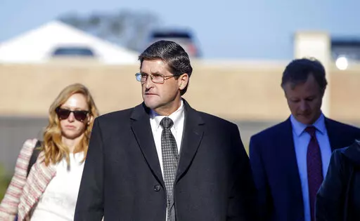 Former St. Tammany Parish Sheriff Jack Strain, center, walks into the parish courthouse before the start of closing arguments in his trial on multiple counts of sex crimes in Covington, La., on Nov. 8, 2021. The former Louisiana sheriff has been sentenced to 10 years in prison on a federal bribery conviction. The sentence was imposed Wednesday, April 6, 2022, on Strain and is to be served concurrently with his four life sentences on recent state convictions for raping boys. (David Grunfeld/The A