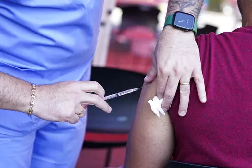 A nurse administers a monkeypox vaccine at a walk-in clinic at the North Jersey Community Research Initiative in Newark, N.J., Tuesday, Aug. 16, 2022.  On Thursday, Aug. 18, 2022, U.S. health officials said they were making extra monkeypox vaccines available to places with events expected to draw crowds of men who have sex with men. (AP Photo/Seth Wenig, File)