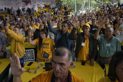 Supporters of opposition leader and former presidential candidate Henrique Capriles raise their hands as they take an oath to support him as the presidential candidate for the Primero Justicia party ahead of the opposition primary in Caracas, Venezuela, Friday, March 10, 2023. Opposition parties for years encouraged voters to boycott elections before urging them to participate in the planned October 2023 primary election to chose a single candidate to face current President Nicolas Maduro at the