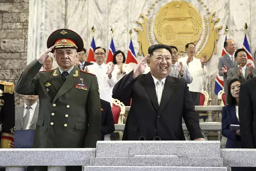 In this photo provided by the North Korean government, North Korean leader Kim Jong Un, center, Russian Defense Minister Sergei Shoigu, left, and China's Vice Chairman of the standing committee of the country's National People's Congress Li Hongzhong, right, attend a military parade to mark the 70th anniversary of the armistice that halted fighting in the 1950-53 Korean War, on Kim Il Sung Square in Pyongyang, North Korea, on July 27, 2023. Shoigu visited Pyongyang in what the U.S. saw as part o