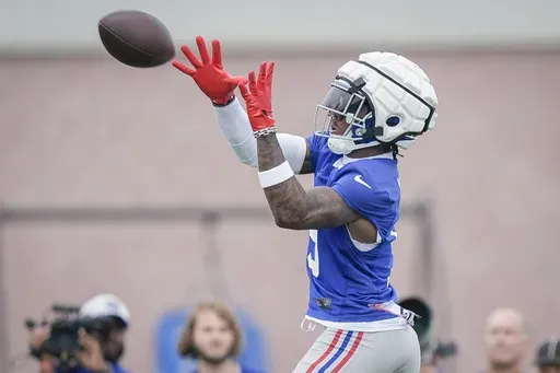 New York Giants wide receiver Malik Nabers (9) catches a pass during NFL football training camp, Wednesday, July 24, 2024, in East Rutherford, N.J. (AP Photo/Bryan Woolston)