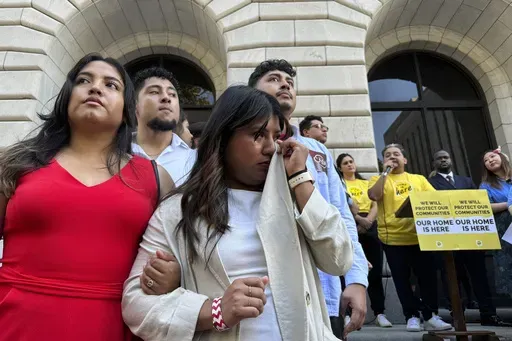 Wendy Reynoso, 24, whose DACA application remains in limbo, wipes tears during a rally outside a federal appeals court in a hearing to decide the future of the policy, in New Orleans, Thursday, Oct. 10, 2024. (AP Photo/Jack Brook)