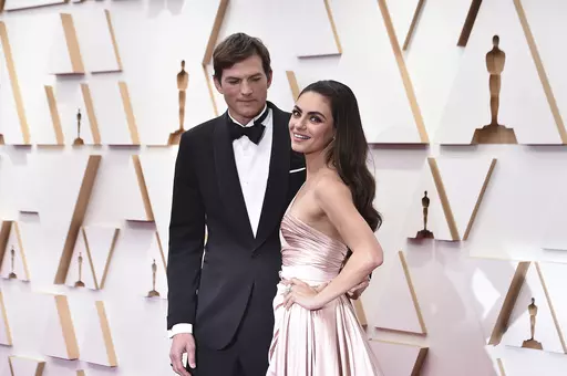Ashton Kutcher, left, and Mila Kunis arrive at the Oscars on Sunday, March 27, 2022, at the Dolby Theatre in Los Angeles. The couple are apologizing for character letters they wrote on behalf of actor Danny Masterson ahead of this week's sentencing of their fellow "That '70s Show" cast member. A judge in Los Angeles on Thursday, Sept. 7, 2023, sentenced Masterson to 30 years to life in prison for raping two women in 2003. (Photo by Jordan Strauss/Invision/AP, File)