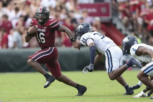 South Carolina quarterback LaNorris Sellers (16) runs away from Old Dominion linebacker Jahleel Culbreath (34) during the first half of an NCAA college football game Saturday, Aug. 31, 2024, in Columbia, S.C. (AP Photo/Artie Walker Jr.)