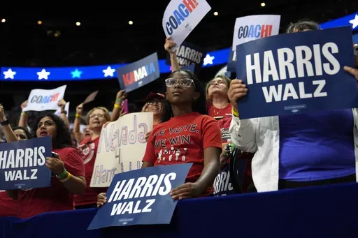 Supporters carry signs as Democratic presidential nominee Vice President Kamala Harris speaks at a campaign rally, Saturday, Aug. 10, 2024, in Las Vegas. (AP Photo/Julia Nikhinson, File)