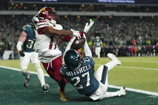 Philadelphia Eagles cornerback Quinyon Mitchell (27) intercepts a pass intended for Washington Commanders wide receiver Terry McLaurin (17) during the second half of the NFC Championship NFL football game, Sunday, Jan. 26, 2025, in Philadelphia. (AP Photo/Derik Hamilton)