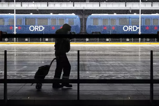 A traveler walks through Terminal 3 at O'Hare International Airport in Chicago, Ill., Dec. 28, 2021. In NerdWallet’s annual analysis of airline mile valuations, holiday flights often don’t provide the highest per-mile value. For example, Delta, Southwest or American Airlines miles are generally worth 1.5 cents each when redeemed for flights. However, they’re only worth about 1.4 cents when you use them for flights around the holidays. (AP Photo/Nam Y. Huh)