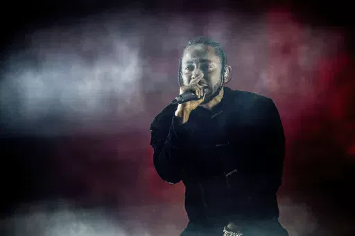Kendrick Lamar performs at Coachella Music & Arts Festival at the Empire Polo Club on Sunday, April 16, 2017, in Indio, Calif. Kendrick Lamar turned his Juneteenth “Pop Out” concert into a celebration of Los Angeles unity. The 37-year-old rapper curated a three-hour livestreamed concert featuring a mix of up-and-coming LA rappers and stars including Dr. Dre and Tyler, The Creator. (Photo by Amy Harris/Invision/AP, File)