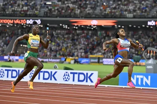 FILE = Sha'Carri Richardson, of the United States celebrates anchoring her team to gold ahead of Shericka Jackson, of Jamaica in the Women's 4x100-meters relay final during the World Athletics Championships in Budapest, Hungary, Saturday, Aug. 26, 2023. When all the other fastest runners and best jumpers and throwers of 2024 line up for the Olympic track and field meet, little of what they've done on the road to Paris will mean much. What will matter is how they respond to pressure when the spot