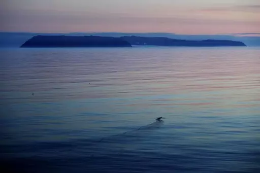 The American island of Little Diomede, Alaska, left, and on the right, the Russian island of Big Diomede, are seen from the Finnish icebreaker MSV Nordica in the Bering Strait, on July 14, 2017. The Alaska Air National Guard on April 3, 2023, traveled nearly 660 miles to rescue a pregnant woman on a small island two miles from Russia who had severe abdominal pains, a reflection of the challenges patients face in the nation's largest state where the most remote areas have no roads and hospitals c
