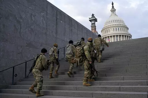 National Guard members take a staircase toward the U.S. Capitol building before a rehearsal for President-elect Joe Biden's Presidential Inauguration in Washington, Jan. 18, 2021. Soldiers are leaving the Army National Guard at a faster rate than they are enlisting, fueling concerns that in the coming years units around the country may not meet military requirements for overseas and other deployments. Officials say the number of soldiers retiring or leaving the Guard each month in the past year 