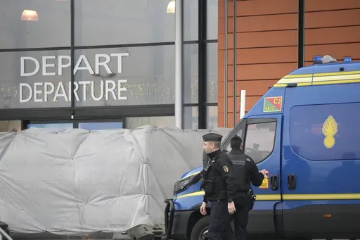 Gendarmes patrol at the Vatry airport, eastern France, Saturday, Dec. 23, 2023 in Vatry, eastern France. About 300 Indian citizens heading to Central America were sequestered in a French airport for a third day Saturday because of an investigation into suspected human trafficking, authorities said. The 15 crew members of the Legend Airlines charter flight en route from United Arab Emirates to Nicaragua were questioned and released, according to a lawyer for the small Romania-based airline. (AP P
