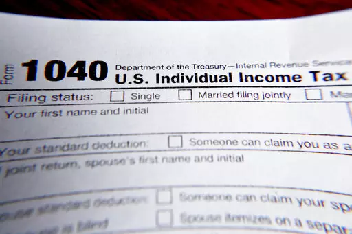 This Wednesday, Feb. 13, 2019 file photo shows part of a 1040 federal tax form printed from the Internal Revenue Service website, in Zelienople, Pa.  As the income tax filing deadline approaches, taxpayers will be facing unexpected tax situations brought about by the turbulent events of last year. Some taxpayers might get refunds and breaks they didn’t anticipate, while others could be paying more than they set aside.  (AP Photo/Keith Srakocic, File)