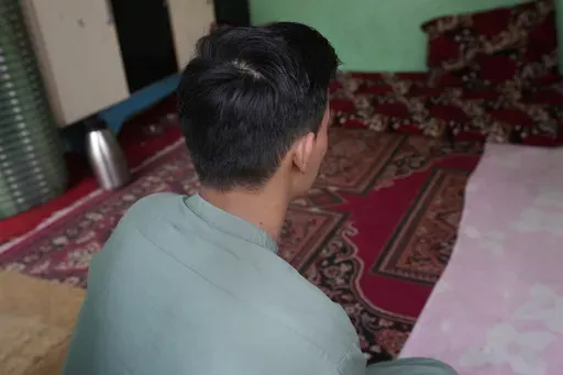 An 18-year-old Afghan boy, who asked not to use his name and not to show his face fearing his identity could lead to his capture again, pose for photograph during an interview with The Associated Press, in Karachi, Pakistan, Friday, Jan. 26, 2024. Born and raised in Pakistan to parents who fled neighboring Afghanistan half a century ago, an 18-year-old found himself at the mercy of police in Karachi who took his cash, phone and motorbike, and sent him to a deportation center. (AP Photo/Fareed Kh