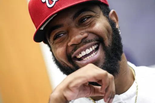 Former Southern University football player Devon Gales smiles as he speaks during an interview Friday, Dec. 16, 2022, at Jefferson Academy in Jefferson, Ga. Gales, who suffered a spinal cord injury and left paralyzed during a game against Georgia in 2015, works at the school while finishing his college degree at Georgia. . (AP Photo/John Bazemore)