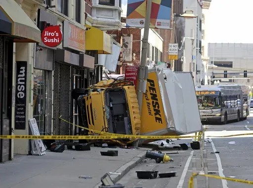 A box truck rests on a sidewalk following a crash, which injured several people in the Chinatown neighborhood of Boston on Tuesday April 1, 2025. (Matt Stone /The Boston Herald via AP)