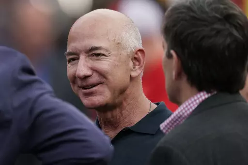 Amazon founder Jeff Bezos is seen on the sidelines before the start of an NFL football game, Sept. 15, 2022, in Kansas City, Mo. The founder of Amazon is buying a home on an exclusive barrier island in Miami where he'll be neighbors with Tom Brady, Ivanka Trump and her husband, Jared Kushner. (AP Photo/Charlie Riedel, File)