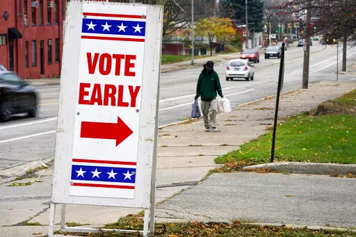 A sign is seen outside a polling station Tuesday, Oct. 25, 2022, in Milwaukee. Tuesday is the first day to vote early in Wisconsin. (AP Photo/Morry Gash)