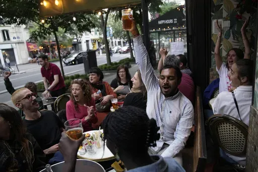People react to the projection of results during the second round of the legislative elections, near Republique Plaza in Paris, France, on July 7, 2024. For many French voters of diverse backgrounds, last Sunday’s parliamentary election results were a relief, seemingly an embrace of the country’s ethnic heterogeneity instead of a victory for xenophobic far-right forces. (AP Photo/Christophe Ena, File)