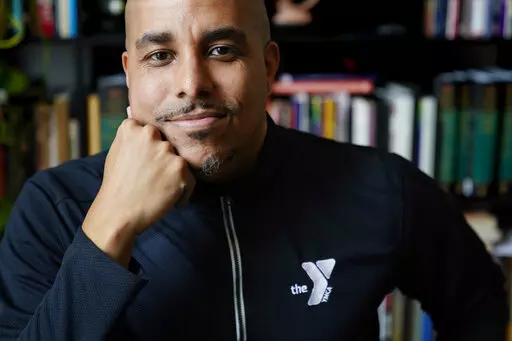 Rico X poses at his home March 14, 2022, in Hermitage, Tenn. X, who oversees the before- and afterschool programs run by the YMCA of Middle Tennessee, says enrollment has had to be capped as parents return to work after the COVID pandemic because of staff shortages, leaving capacity at about 70% of what it was before the pandemic. (AP Photo/Mark Humphrey)