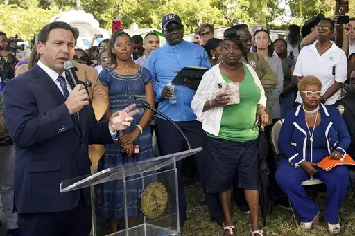 Florida Gov. Ron DeSantis, left, speaks at a prayer vigil for the victims of a mass shooting a day earlier, in Jacksonville, Fla., Sunday, Aug. 27, 2023. (AP Photo/John Raoux, File)