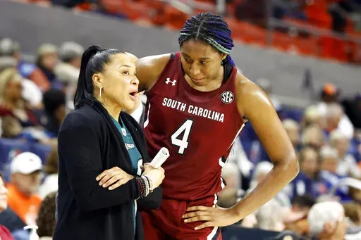 South Carolina head coach Dawn Staley, left, talks with forward Aliyah Boston (4) during the second half of an NCAA college basketball game against Auburn, on Feb. 9, 2023, in Auburn, Ala. One thing's nearly certain when LSU's Angel Reese and South Carolina's Aliyah Boston face off Sunday in a showdown of the country's last two undefeated teams: Someone, if not both, will come away with a double-double. (AP Photo/Butch Dill, FIle)