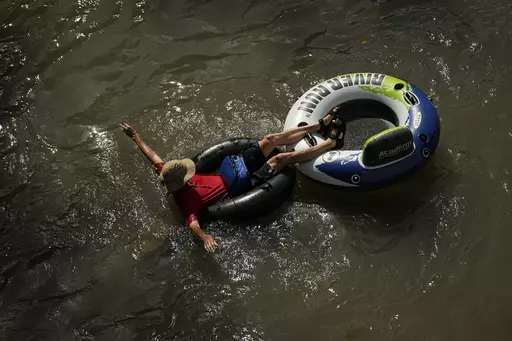 A tuber floats on the Comal River, July 26, 2023, in New Braunfels, Texas, as the area continues to feel the effects of triple-digit temperatures. Record setting temperatures are expected Saturday, Aug. 19, across Texas as the southwestern U.S. continues to bake during a scorching summer. (AP Photo/Eric Gay, File)