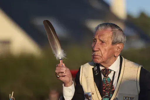 FILE — WWII veteran Charles Shay, pays tribute to soldiers during a D-Day commemoration ceremony of the 78th anniversary for those who helped end World War II, in Saint-Laurent-sur-Mer, Normandy, France, Monday, June 6, 2022. On D-Day, Charles Shay was a 19-year-old Native American army medic who was ready to give his life — and actually saved many. Now 99, he's spreading a message of peace with tireless dedication as he's about to take part in the 80th celebrations of the landings in Norman
