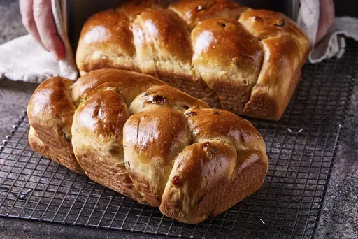 This image released by Milk Street shows a recipe for olive oil challah with golden raisins. (Milk Street via AP)