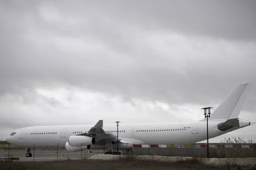 The plane reported to carry some 300 Indian citizens parks at the Vatry airport, eastern France, Saturday, Dec. 23, 2023 in Vatry. About 300 Indian citizens heading to Central America were sequestered in a French airport for a third day Saturday because of an investigation into suspected human trafficking, authorities said. The 15 crew members of the Legend Airlines charter flight en route from United Arab Emirates to Nicaragua were questioned and released, according to a lawyer for the small Ro