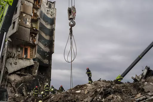 Firefighters work on a destroyed apartment building in the town of Borodyanka, Ukraine, on Saturday, April 9, 2022. Russian troops occupied the town of Borodyanka for weeks. Several apartment buildings were destroyed during fighting between the Russian troops and the Ukrainian forces in the town around 40 miles northwest of Kiev. (AP Photo/Petros Giannakouris)